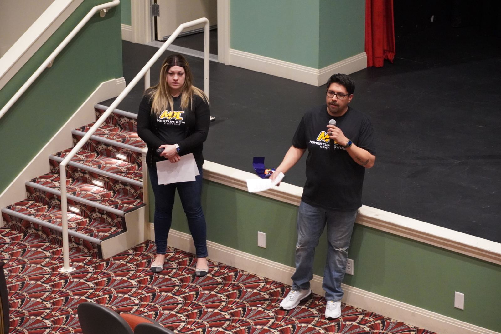 Two founders presenting their business to the judging panel on stage at the 2023 Pitch Night